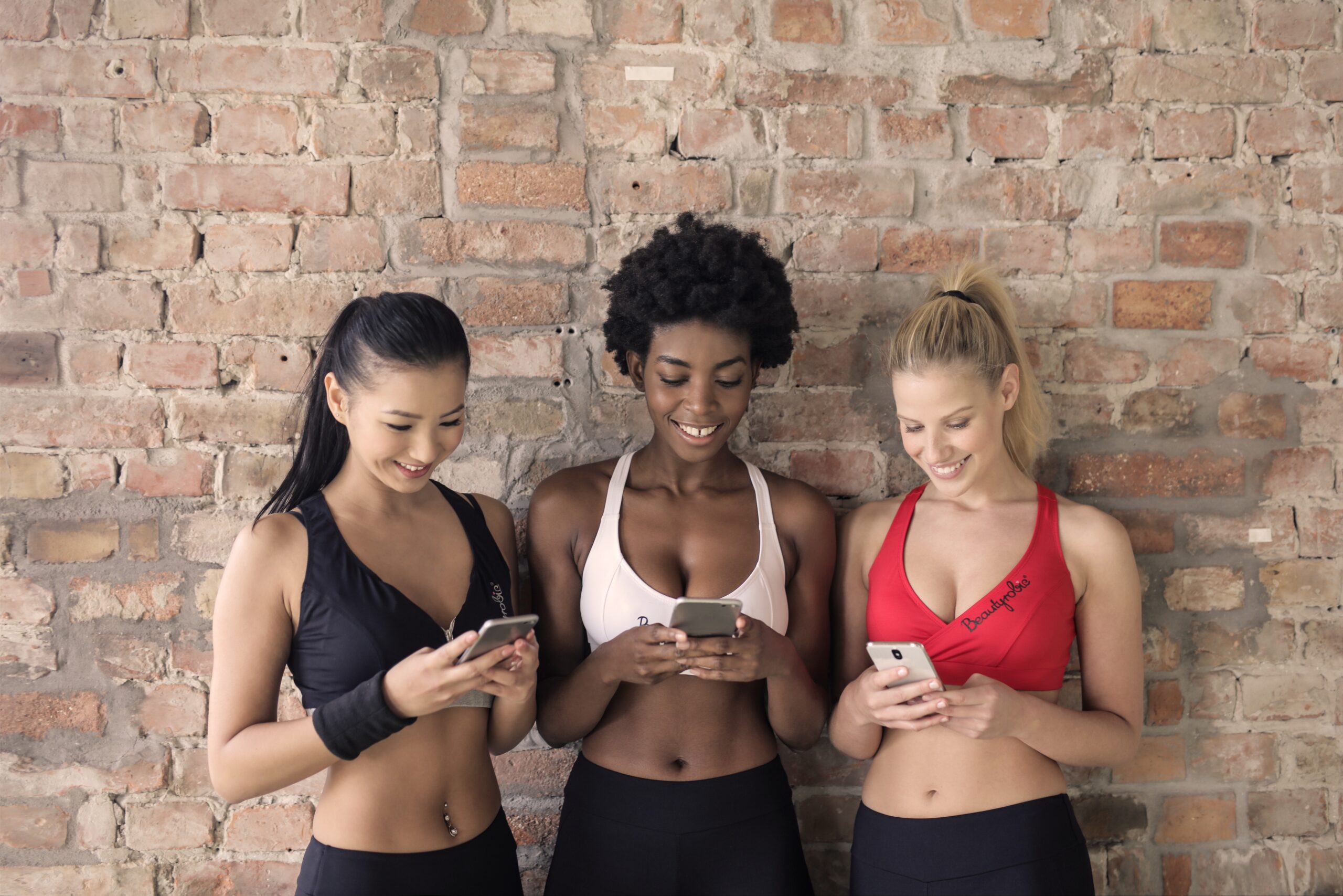women checking fitness apps for workout